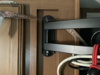 Mounting bracket screwed into 2x4 behind cabinet face.